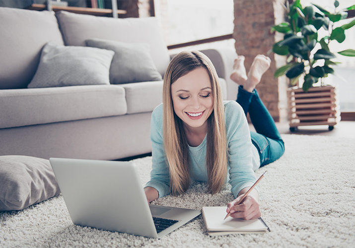 Lady on floor with laptop web 715x500