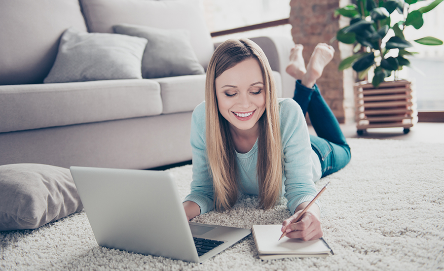 Lady on floor with laptop web 900x550